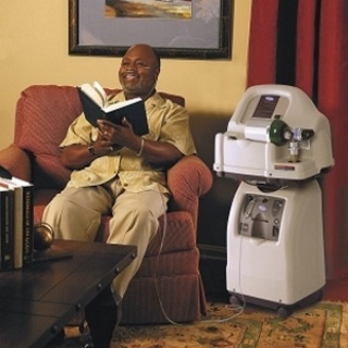 man reading book beside home fill oxygen station